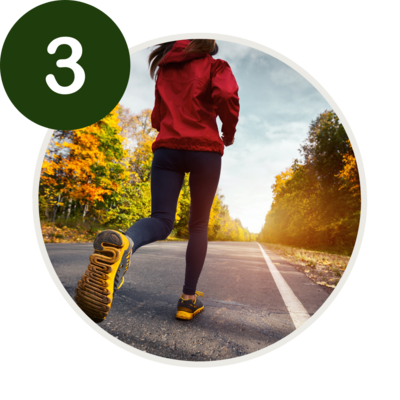 a woman running down a road 