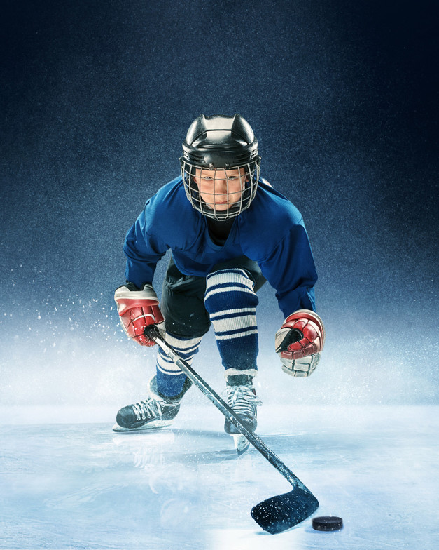 Kid that is skating towards the camera in hockey gear