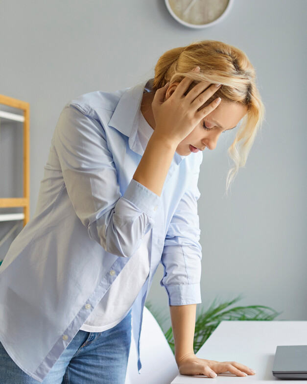 a lady holding her head dizzy