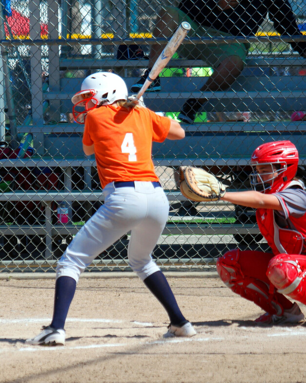 a girl up to bat in baseball 